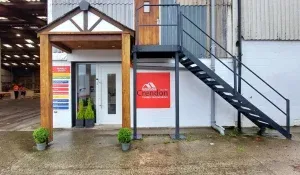 Entrance to Crendon office with timber porch and warehouse to the side
