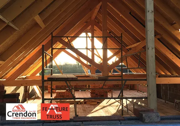 Feature Trusses placed into a roof under construction at sunset
