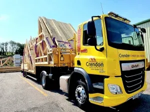 Yellow lorry loaded with Roof Trusses