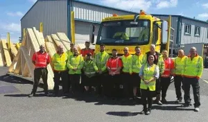 Crendon team posing in front of a lorry and warehouse