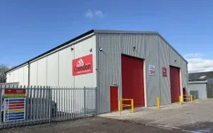 Grey warehouse with red shutters