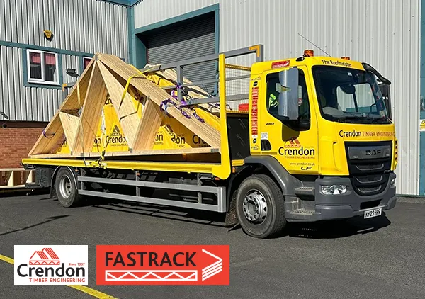 Loaded yellow lorry in front of warehouse
