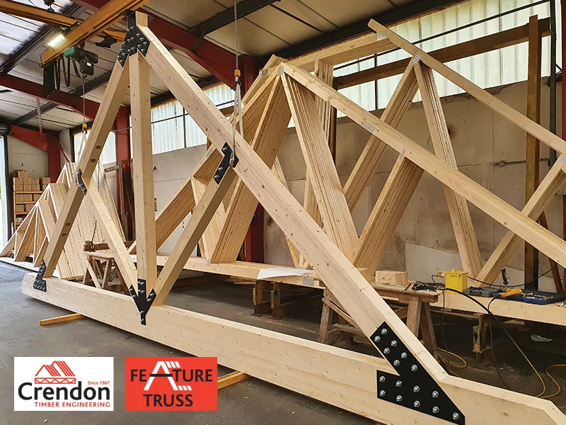 Feature Truss being held up with cords in front of Roof Trusses