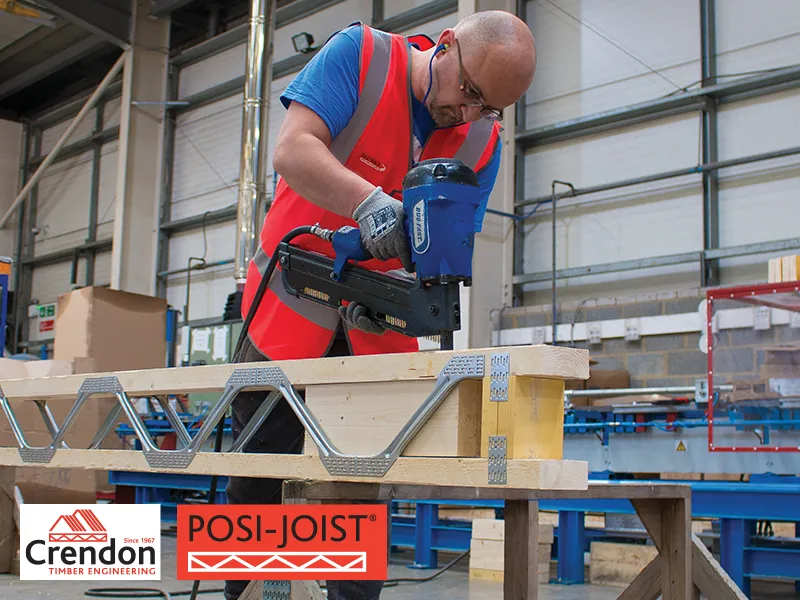 Crendon worker attaching materials together using a nail gun in a workshop