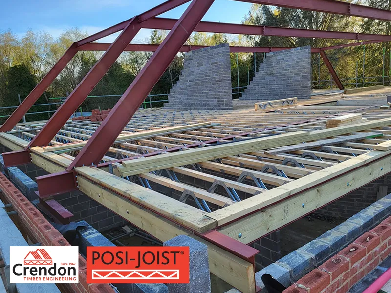 Building under construction with Posi-Joists creating the roof and burgundy steel frame